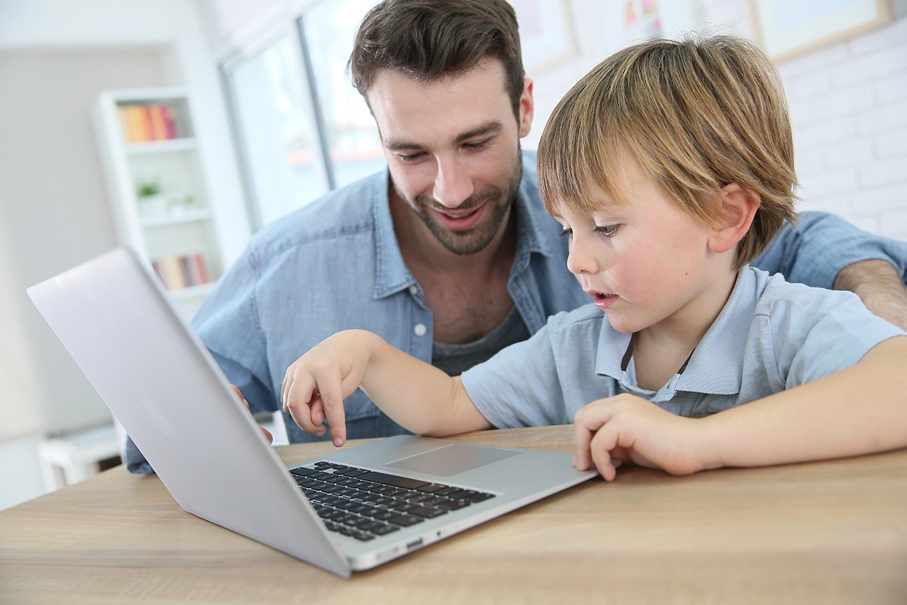 Man and son sitting with a laptop.