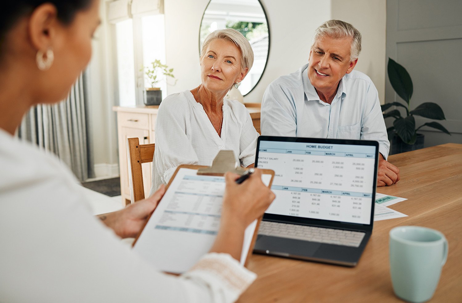 Mature couple reviewing their estate plan with their financial planner.