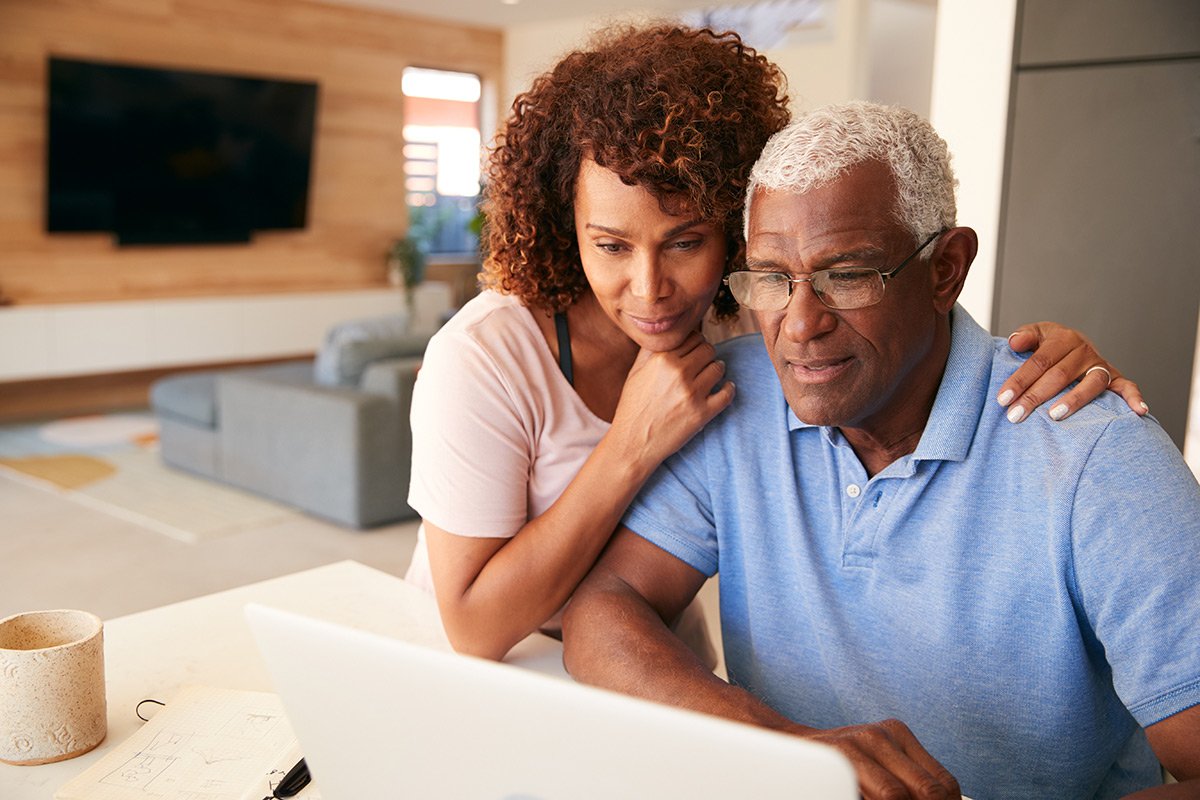 African American couple looking at their finances on a laptop.