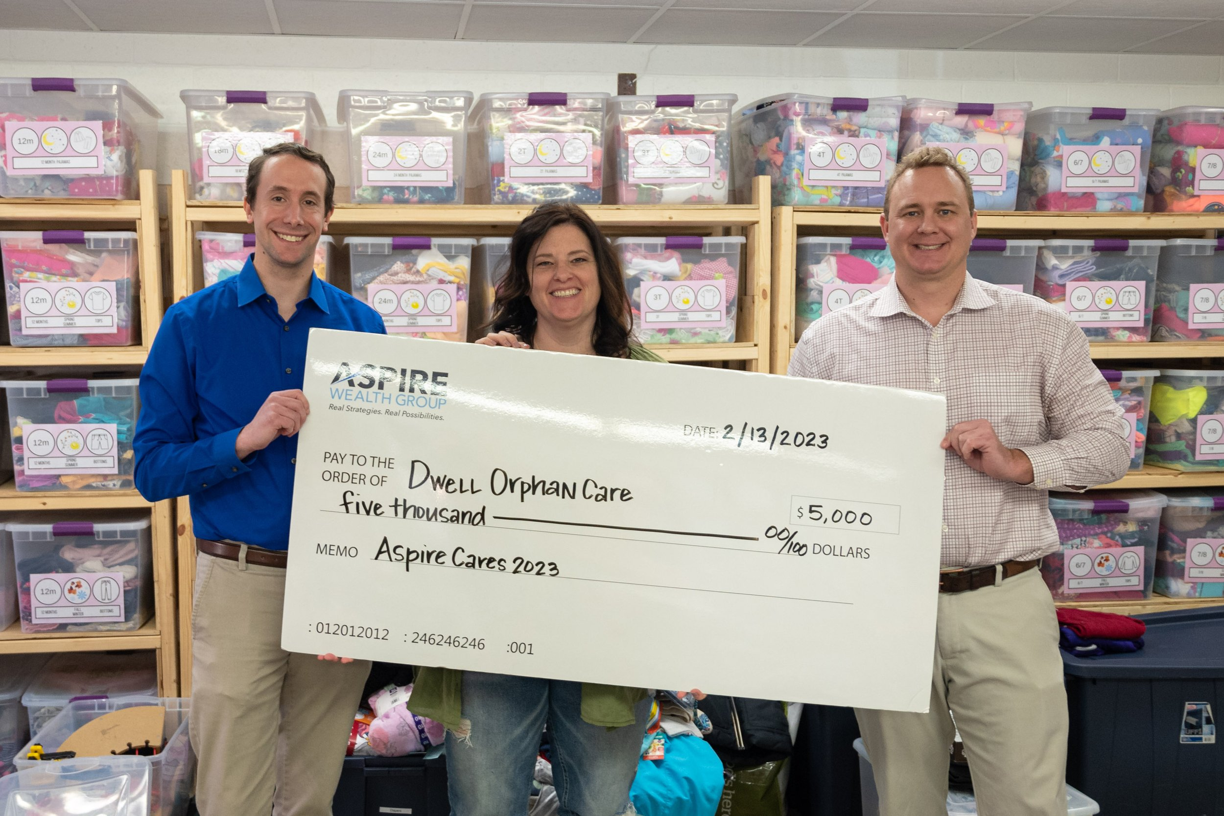 Aspire Cares Dwell Orphan Care check presentation.