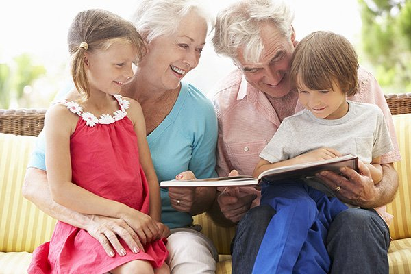 Grandparents reading to their grandchildren.