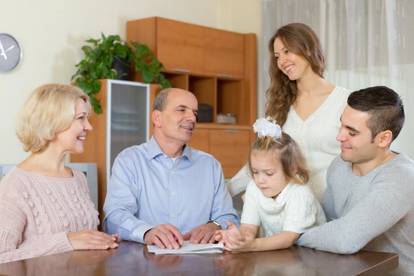 Multigenerational family meeting discussing wealth matters.