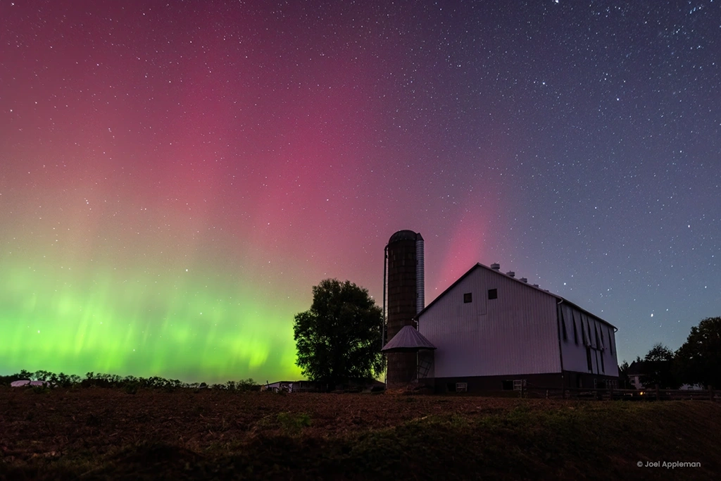 The northern lights light up the sky over a barn near Milton, Pennsylvania.