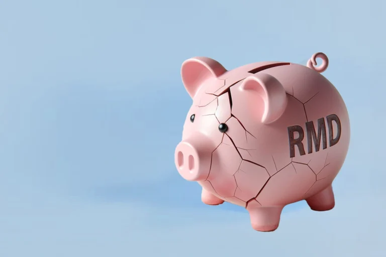 A cracked pink piggy bank with the letters RMD on the side, on a blue background.