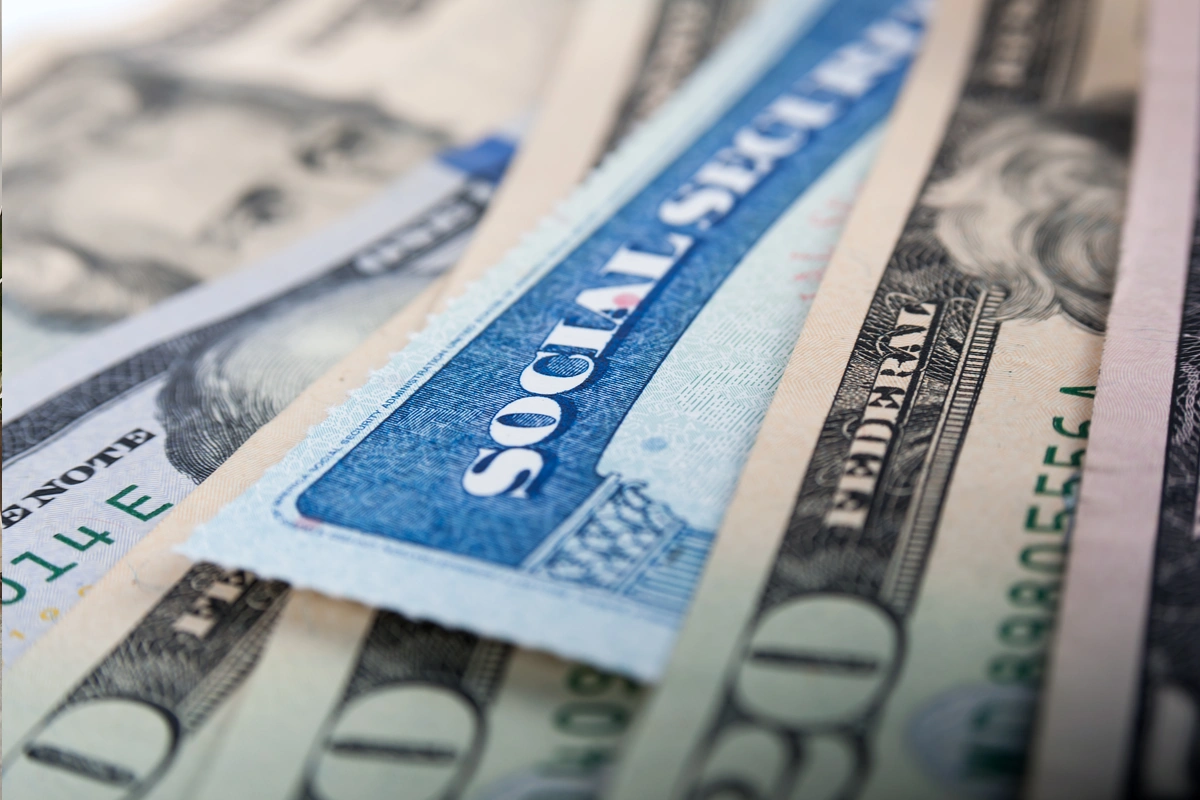 Close-up of a Social Security card among currency