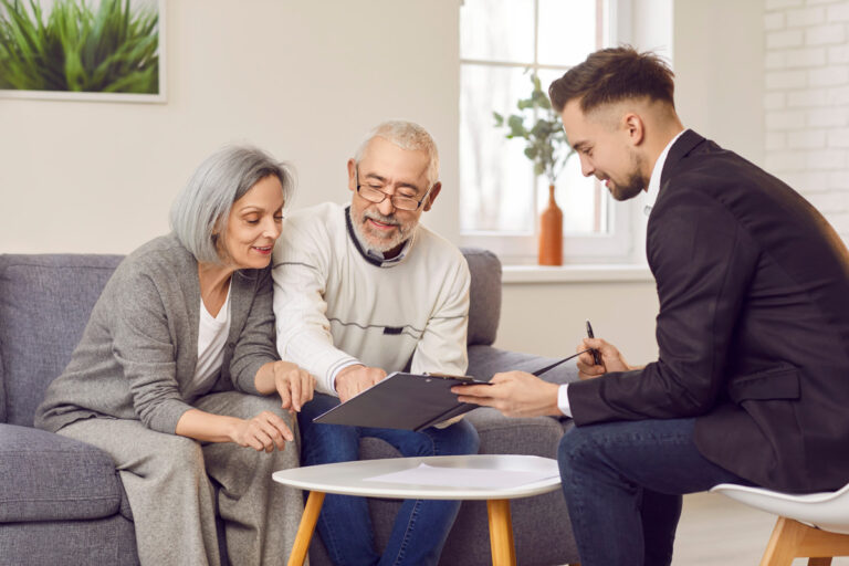 Couple meeting with their independent financial advisor in their living room.